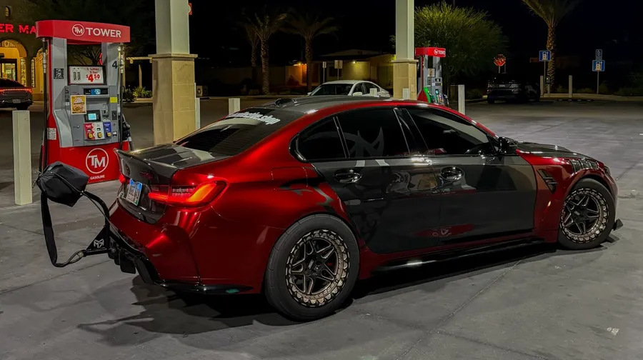 PSI Garage shop car from the side: red BMW M3 with black carbon doors